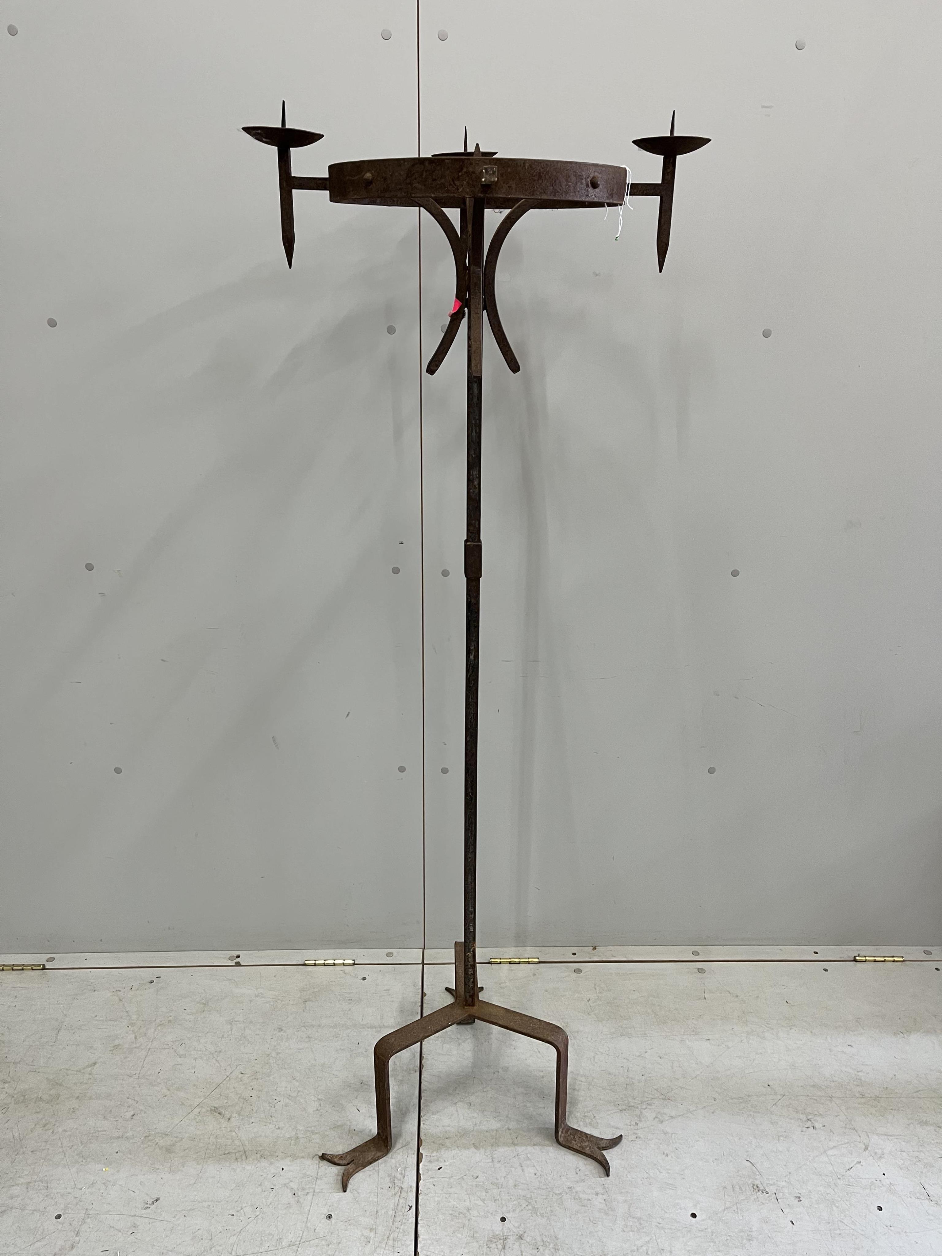 A pair of wrought iron tripod pricket candlestands, height 160cm. Condition - poor, one sconce detached, one missing
